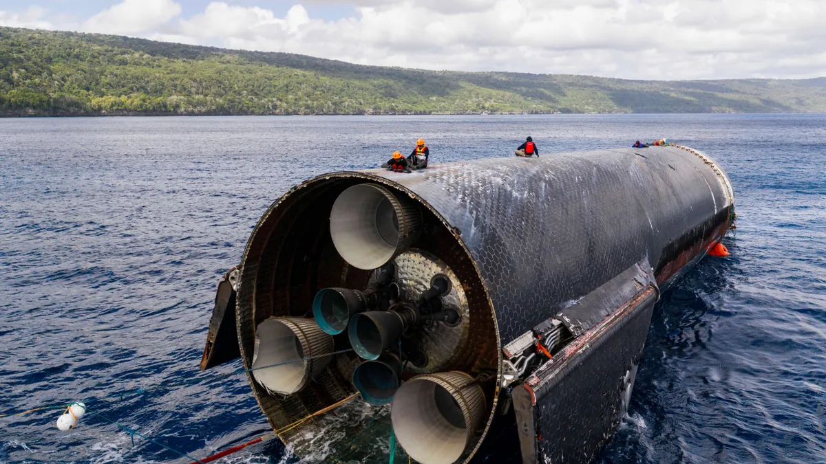 SpaceX engineers inspect Flight 13's Ship as it floats off the coast of Christmas Island. (Image credit: SpaceX)
