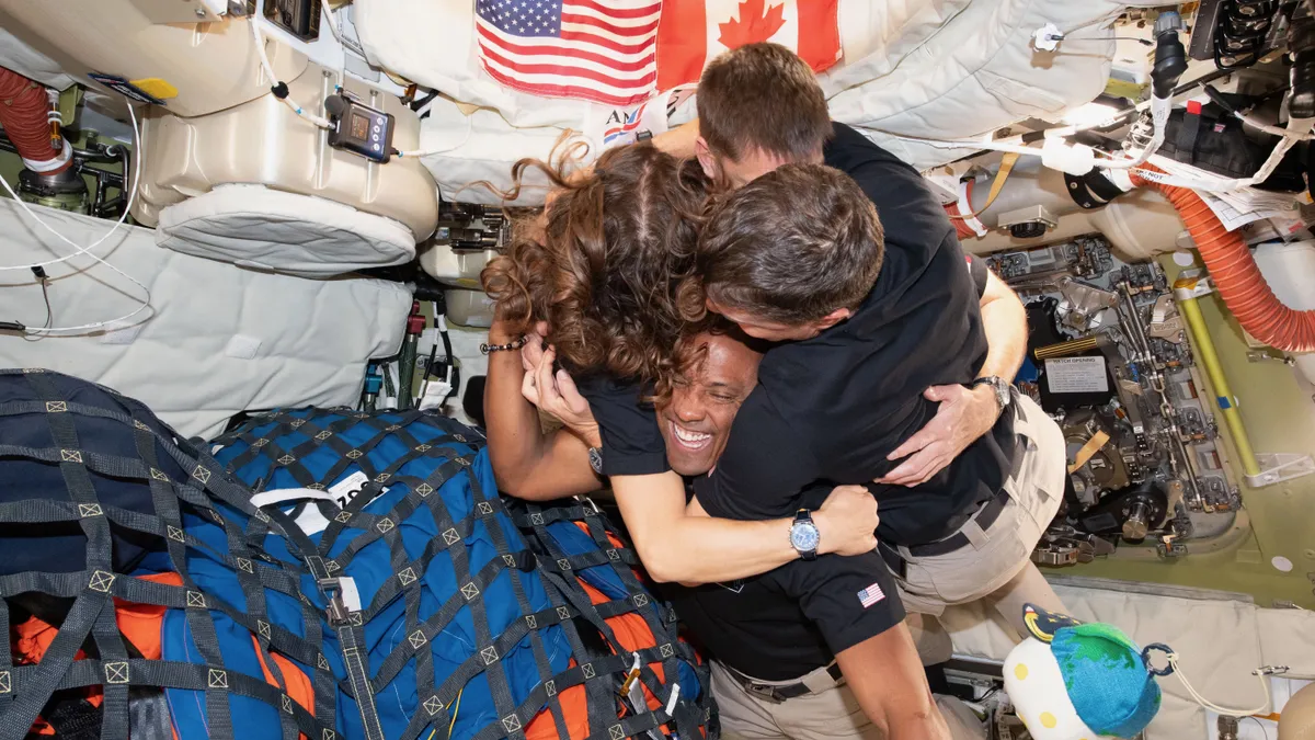 From left: The Artemis II crew — NASA astronaut Christina Koch, Canadian Space Agency astronaut Jeremy Hansen, and NASA astronauts Reid Wiseman and Victor Glover — take time out for a group hug inside the Orion spacecraft on April 6, 2026. (Image credit: NASA)